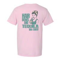 Retro-style graphic t-shirt in Blossom Pink featuring a vintage-inspired woman holding a tequila bottle, printed on the back of a Comfort Colors pocket tee.