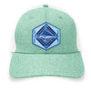 Seafoam green trucker hat with a detailed acrylic blue marlin patch on the front. Features a breathable white mesh back and an adjustable snapback closure. The curved bill provides shade, making it perfect for fishing, boating, and coastal adventures