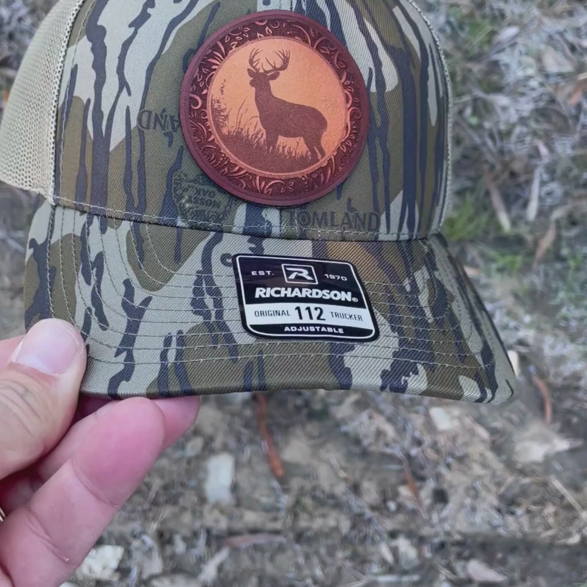 Video of a Richardson Mossy Oak Bottomland camo hat with a leather white tail deer patch.